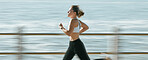Woman, fitness and speed running by beach on mockup for exercise, workout or cardio routine. Active female runner in fast run, sprint or race by the ocean coast for healthy exercising or wellness