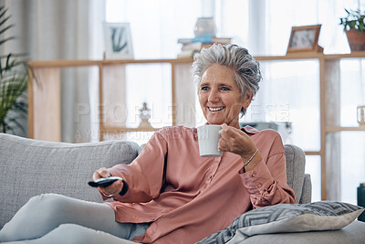 Buy stock photo Senior woman, sofa and coffee to relax with remote for television, video or movies with smile in house. Elderly lady, couch and tea with happiness in home living room for watching tv in retirement