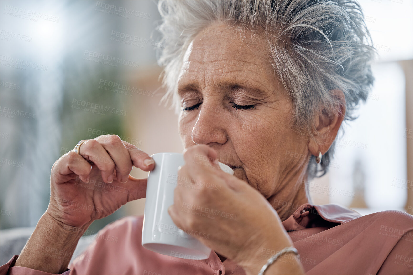 Buy stock photo Elderly woman, sofa and coffee to relax with drink for peace, quiet and me time to start morning in house. Senior lady, couch and tea for happiness, thinking and memory from aroma in home living room