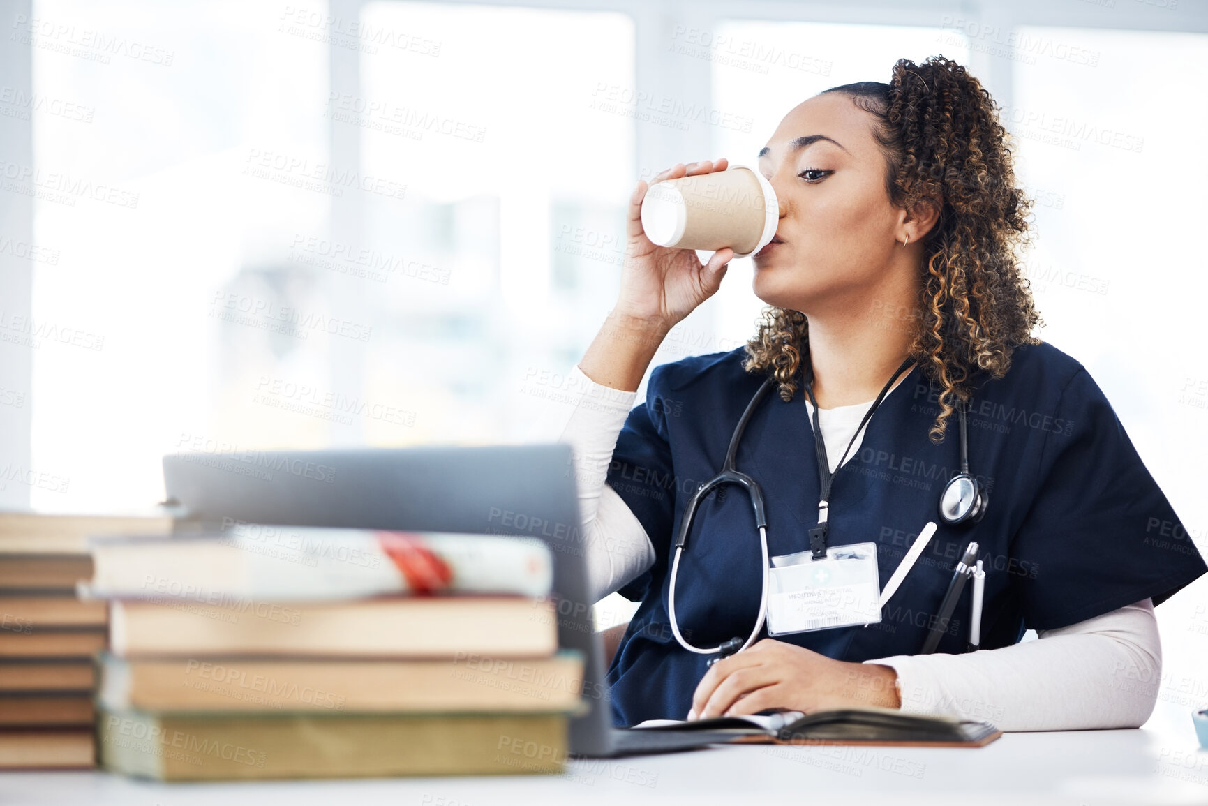 Buy stock photo Medical student, laptop or drinking coffee in hospital studying, education books research or wellness learning school. Thinking, nurse or healthcare woman and drink, technology or medicine internship