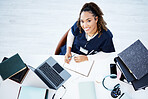 Top view, portrait or nurse on hospital laptop research, education woman studying or books learning for medical student. Above, smile or happy doctor on healthcare technology in medicine internship