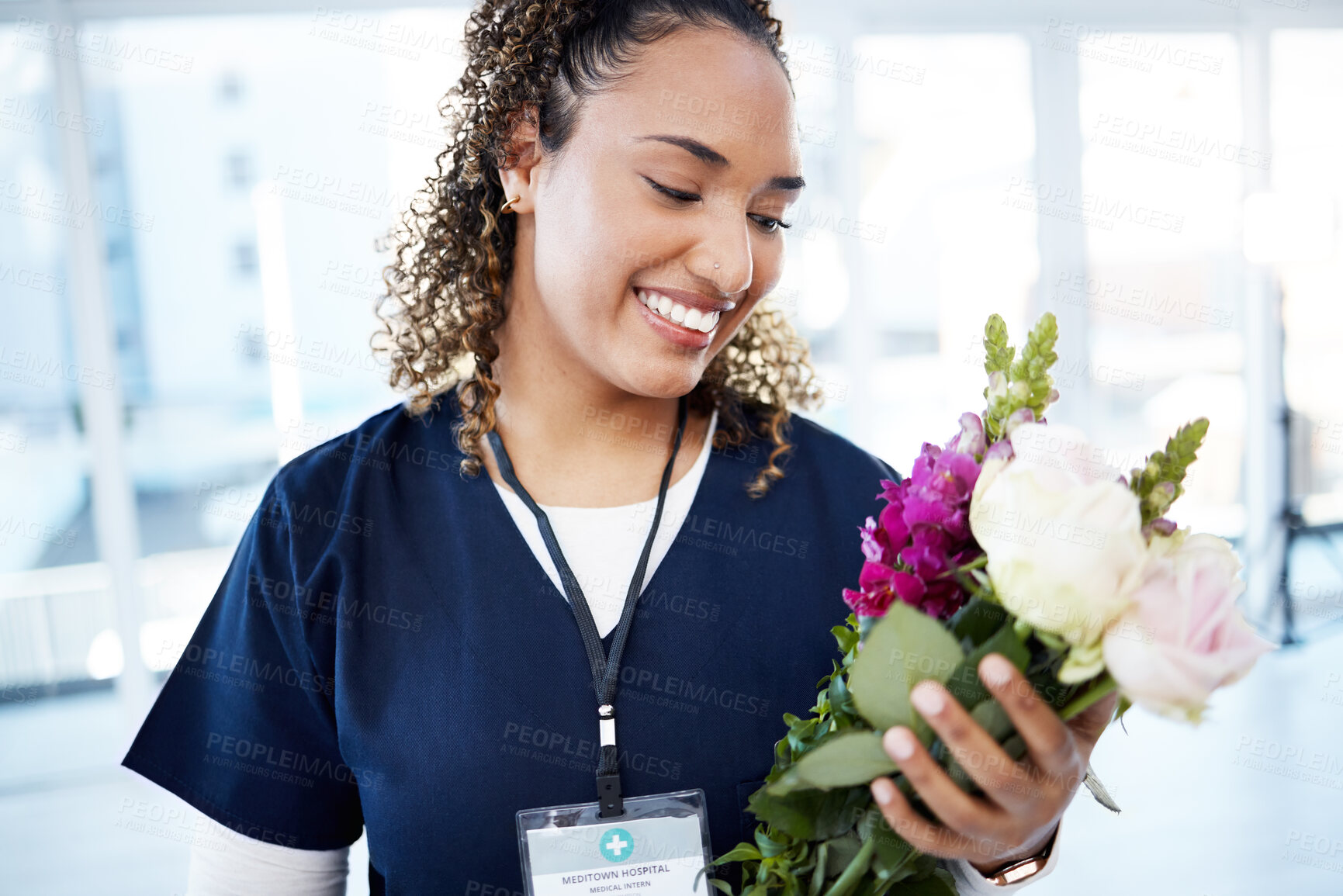 Buy stock photo Achievement, celebration and a doctor with flowers at a hospital for a promotion and gift for work. Care, happy and female nurse with a bouquet as a present for promotion in healthcare nursing job