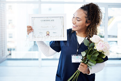 Buy stock photo Certificate, flowers and a black woman graduate in the hospital feeling proud of her achievement. Smile, graduation and qualification with a happy young female nurse standing alone in a clinic