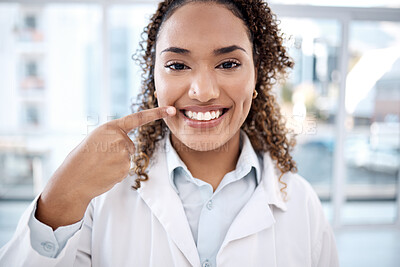 Buy stock photo Portrait of black woman pointing to teeth whitening results, dentist medical and mouth healthcare in hospital. Professional dental doctor with tooth cleaning services and happy face in USA clinic