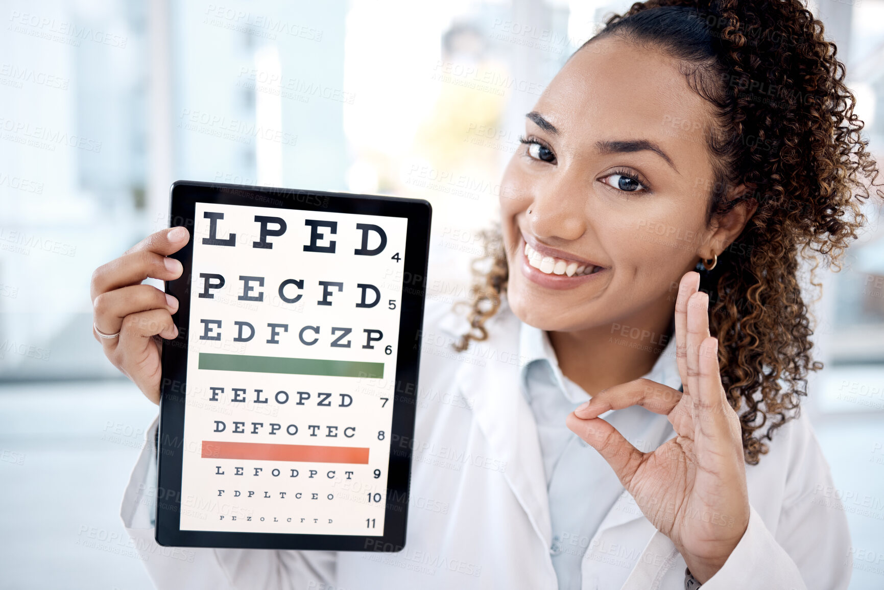 Buy stock photo Optometry chart, tablet and doctor with ok sign in hospital for vision examination in clinic. Healthcare, snellen touchscreen and optometrist or black woman with tech, hand gesture and eyes test text