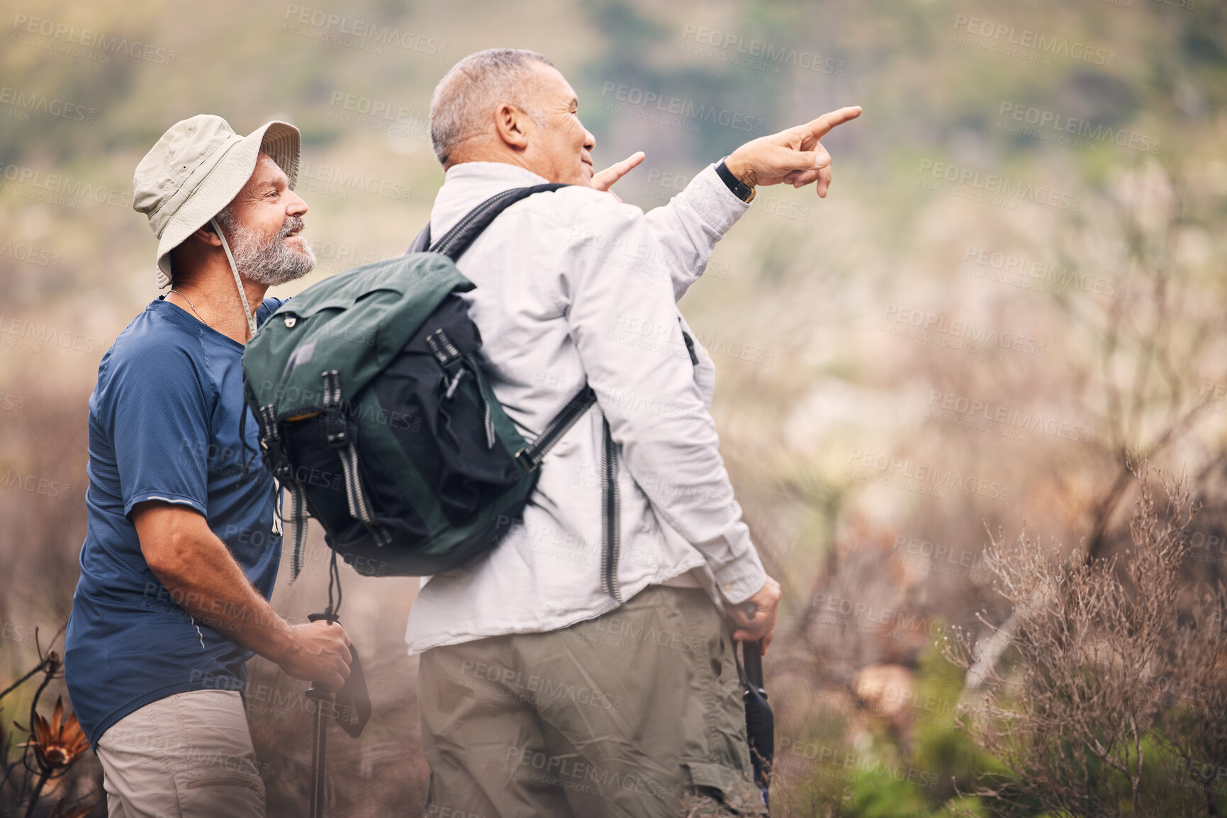 Buy stock photo Hiking, pointing and senior men in nature for travel, walking and on a backpack adventure in Spain. Search, view and elderly friends doing bird watching and looking at environment in the mountains