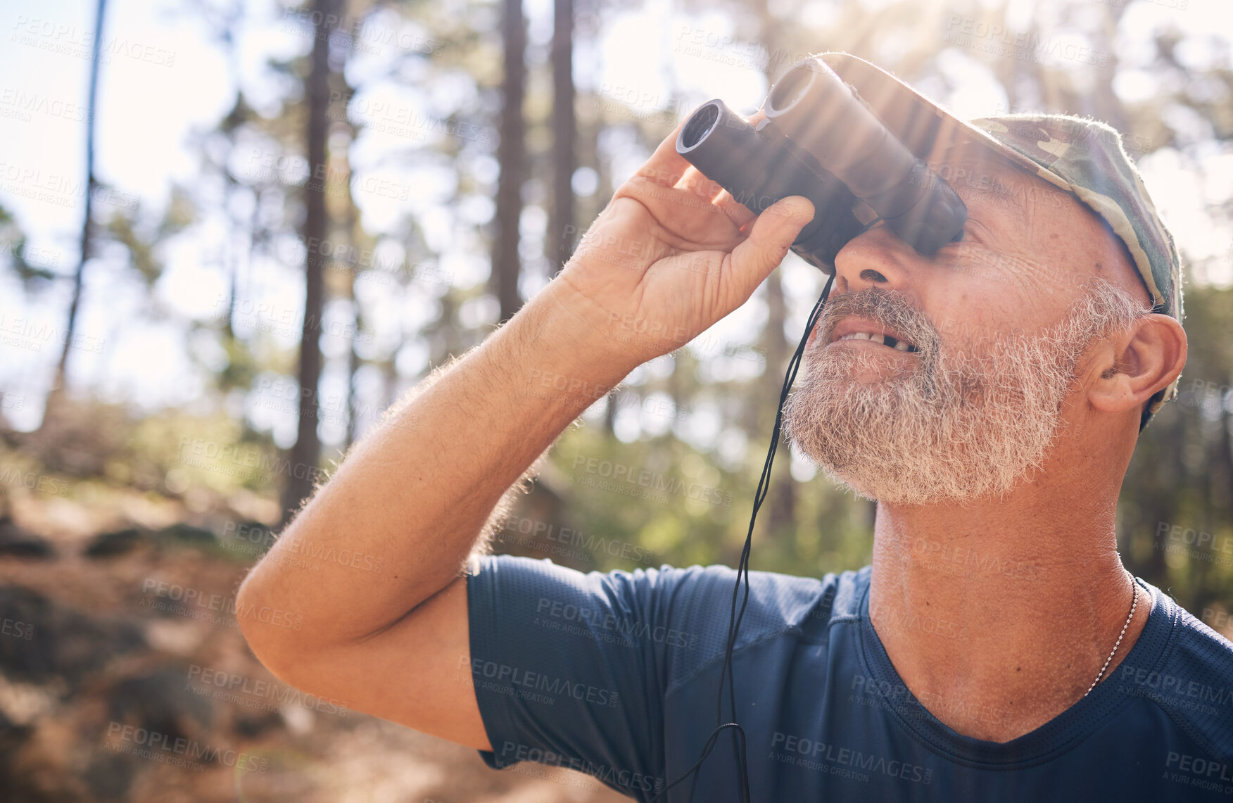 Buy stock photo Binoculars, senior man and hiking in nature looking at view, sightseeing or watching. Binocular face, adventure search and elderly male with field glasses, trekking or exploring on vacation outdoors.