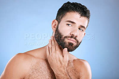 Buy stock photo Idea, skincare and grooming with a man model in studio on a blue background for natural wellness or beauty. Face, beard and skin with a handsome young male thinking about cosmetics or treatment