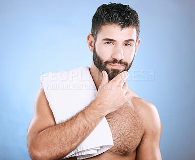 Buy stock photo Portrait, skincare and man with towel, cleaning and hygiene on blue studio background. Face detox, male and gentleman washing, dermatology and morning routine for grooming, treatment and smooth skin