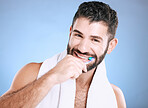 Toothbrush, portrait and man brushing teeth in studio for dental wellness, healthy smile and mouth. Happy male model, oral care and fresh breath for gums, dentistry and hygiene on blue background 