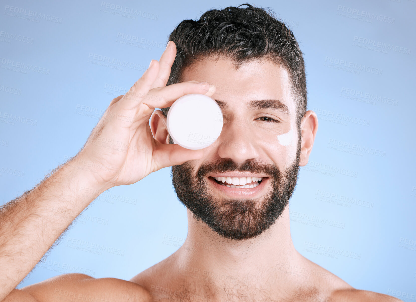 Buy stock photo Cream, skincare jar and man for face, body and happy cosmetics in studio blue background. Facial lotion, male portrait and product for beauty, container and aesthetic for healthy glow, shine or smile