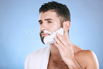 Buy stock photo Facial, man putting foam on beard with hand on face, towel and product placement in studio mock up. Shaving cream, hair and skincare for male model grooming, isolated on blue background with space.