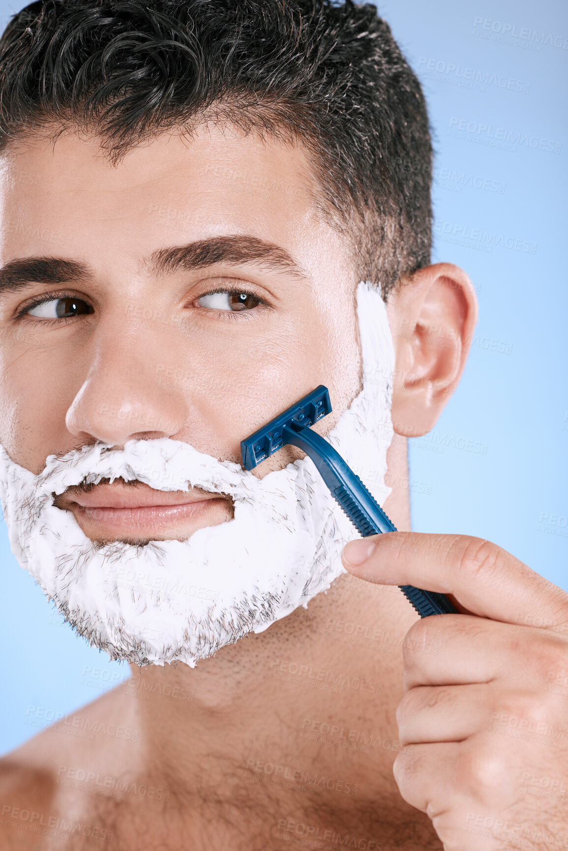 Buy stock photo Shaving, beard and cosmetic man with cream for grooming isolated on a blue background. Skincare, beauty and model with razor to shave hair on face with foam for a clean facial look on a backdrop