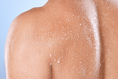 Buy stock photo Water drop, skincare and back of man in studio for cleaning, body care or cosmetic on blue background. Shower, skin and guy wellness model relax in luxury, moisture and gentle, cleansing or treatment
