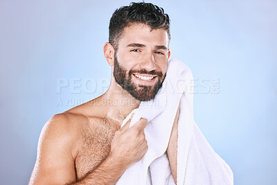 Buy stock photo Man, face and shower with hygiene, towel and beauty in portrait, smile and grooming in studio. Skincare, cosmetics and clean face with healthy skin, mockup and cosmetic care on blue background