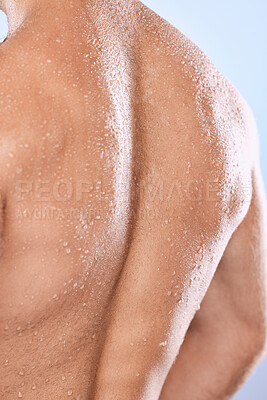 Buy stock photo Man, back and water drops for shower on background of skincare, hygiene and healthy dermatology. Closeup behind torso, strong male and wet human body with muscle, anatomy cleaning and studio wellness