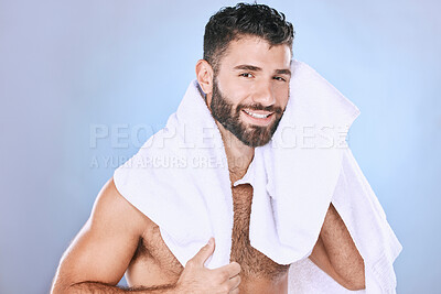 Buy stock photo Man after shower with hygiene, towel and beauty in portrait, smile, face and grooming in studio. Skincare, cosmetics and cleaning body with healthy skin, mockup and cosmetic care on blue background