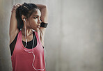 Fitness, focus woman and stretching with earphones on mockup space for exercise, workout and training. Serious female athlete warm up to music for runner motivation, mindset goals and sports energy