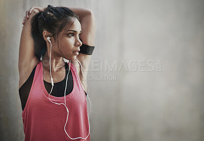 Buy stock photo Fitness, focus woman and stretching with earphones on mockup space for exercise, workout and training. Serious female athlete warm up to music for runner motivation, mindset goals and sports energy