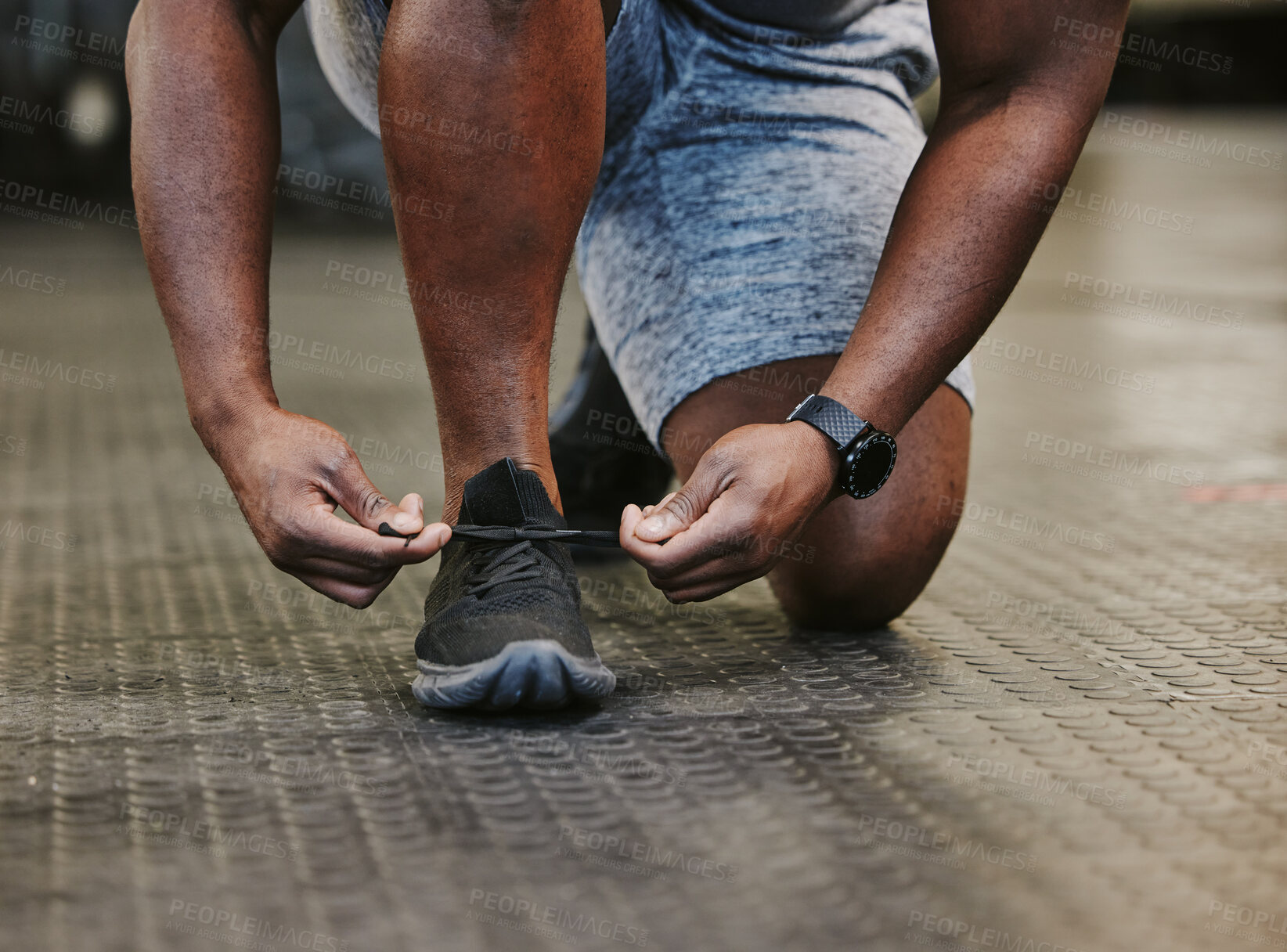 Buy stock photo Hands, fitness and tie shoes in gym to start workout, training or exercise for wellness. Sports, athlete health and black man tying sneakers or footwear laces to get ready for exercising or running.