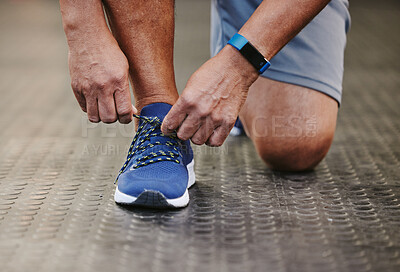 Buy stock photo Hands, tie shoes and fitness in gym to start workout, training or exercise for wellness. Sports, athlete and man tying sneakers or footwear laces to get ready for exercising or running for health.