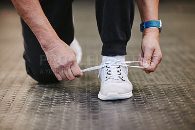 Buy stock photo Fitness, tie shoes and hands in gym to start workout, training or exercise for wellness. Sports, athlete health and senior man tying sneakers or footwear laces to get ready for exercising or running.