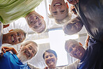 Senior exercise group, teamwork circle and low angle portrait with smile, diversity and support for health. Elderly fitness, team building and solidarity for happiness, hug or motivation for wellness