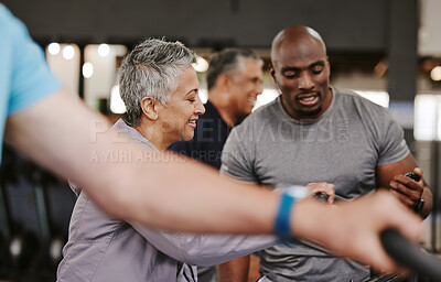 Buy stock photo Senior group, exercise bike and personal trainer for fitness, time and retirement wellness by blurred background. Elderly woman, bicycle training or diversity with black man, stopwatch and motivation