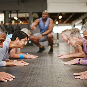 People, fitness and stretching in class at gym for workout, squat exercise  or training together. Diverse