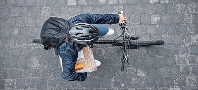 Buy stock photo Top view, bicycle and delivery man with box in city for package, logistics and shipping. Courier, eco friendly transport and male bike driver with cargo, stock or goods for ecommerce on road in town.