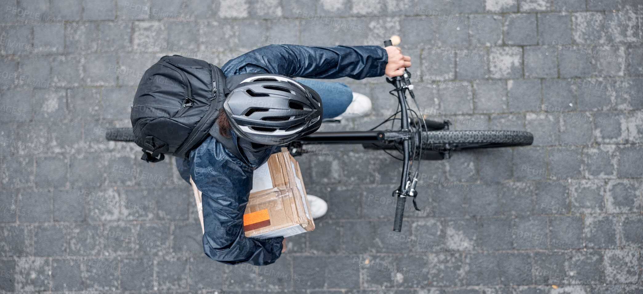 Buy stock photo Top view, bicycle and delivery man with box in city for package, logistics and shipping. Courier, eco friendly transport and male bike driver with cargo, stock or goods for ecommerce on road in town.