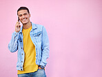 Phone call, happy and portrait of a man in a studio with a casual, trendy and stylish outfit. Happy, smile and male model on mobile conversation with cellphone by a pink background with mockup space.