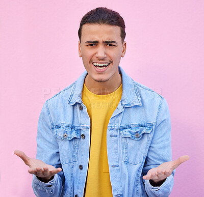 Confused, annoyed and portrait of a man in a studio with a doubt, upset and moody facial expression. Angry, mistake and male model doing sign language or hand gesture isolated by a pink background.