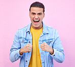 Portrait, winner and shouting in victory with a man in studio on a pastel pink background for cheering. Winning, celebration and screaming with a handsome young male celebrating against a wall