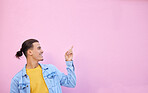 Happy, smile and man pointing in a studio with mockup space for advertising, marketing or product placement. Happiness, excited and male model showing mock up or copyspace isolated by pink background