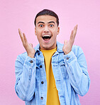 Man, hands and face for surprise in portrait with happiness, excited and pink wall background. Happy gen z model, wow and smile for announcement, fashion and news for career, success and life goal