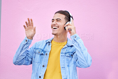 Buy stock photo Headphones, man and happy dance on pink background, wall backdrop or studio mockup. Excited guy listening to music, sound and streaming audio media with freedom, smile and hearing radio for dancing 