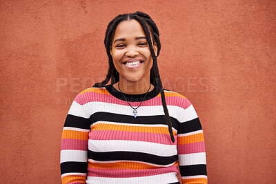 Buy stock photo Portrait, fashion and braids with a black woman on an orange background outdoor for style or empowerment. Style, wellness and profile picture with an african american person posing against a wall