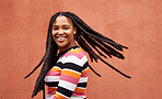 Playful, fun and portrait of a black woman with a smile isolated on a studio background. Happy, laughing and a funny young African girl with dreadlocks, happiness and expression on a backdrop