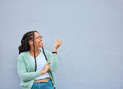 Buy stock photo Mockup, hands and black woman pointing to space for advertising, empty and grey wall background. Hand, gesture and girl relax, happy and smile in studio for product placement, branding and copy space