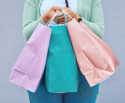 Buy stock photo Fashion, hands or black woman with shopping bag or gift on promotion in retail therapy against wall. Freedom, relaxing or girl on holiday vacation with clothes or products on discounted sales offer