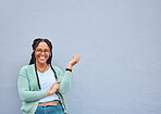 Mockup, portrait and black woman pointing to space for advertising, empty or grey wall background. Face, gesture and girl relax, happy and smile in studio on product placement, isolated or copy space