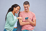 Man, woman and phone by wall for meme, social media or blog post with happiness together in city. Interracial couple, smartphone and happy with smile, comic and funny video on internet app in metro