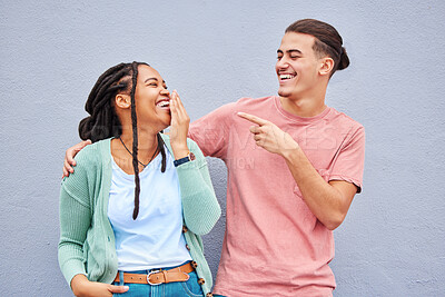 Buy stock photo Joking, laugh and happy with a couple on a gray background, outdoor for fun or freedom together. Laughing, humor or smile with a young man and woman enjoying laughter while bonding against a wall