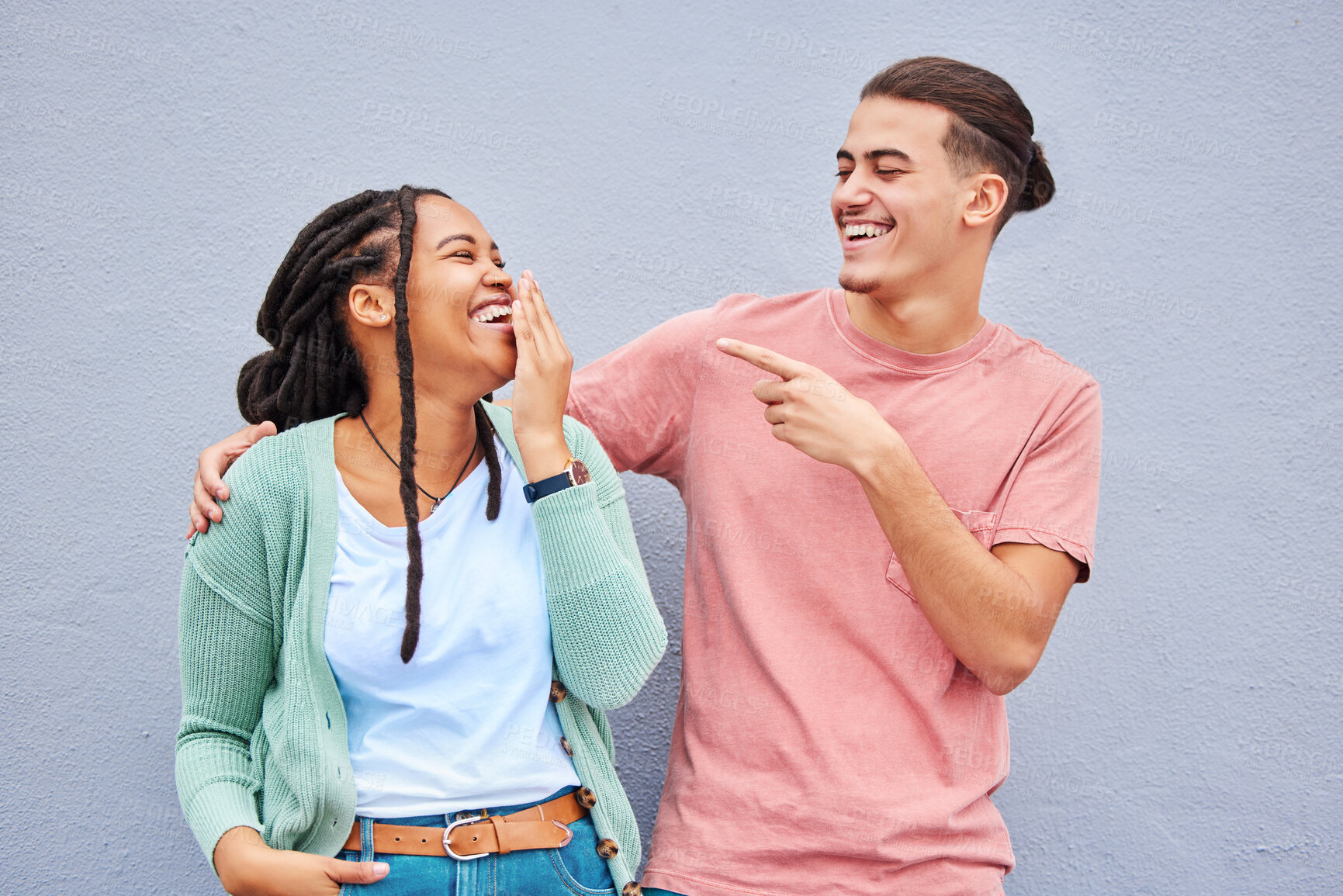 Buy stock photo Joking, laugh and happy with a couple on a gray background, outdoor for fun or freedom together. Laughing, humor or smile with a young man and woman enjoying laughter while bonding against a wall