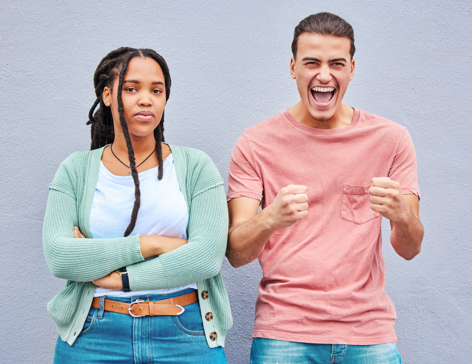 Buy stock photo Bored, excited and portrait of an interracial couple with arms crossed, anger and happy about a win. Sad, smile and young man and woman looking angry, comic and mad about losing in a competition