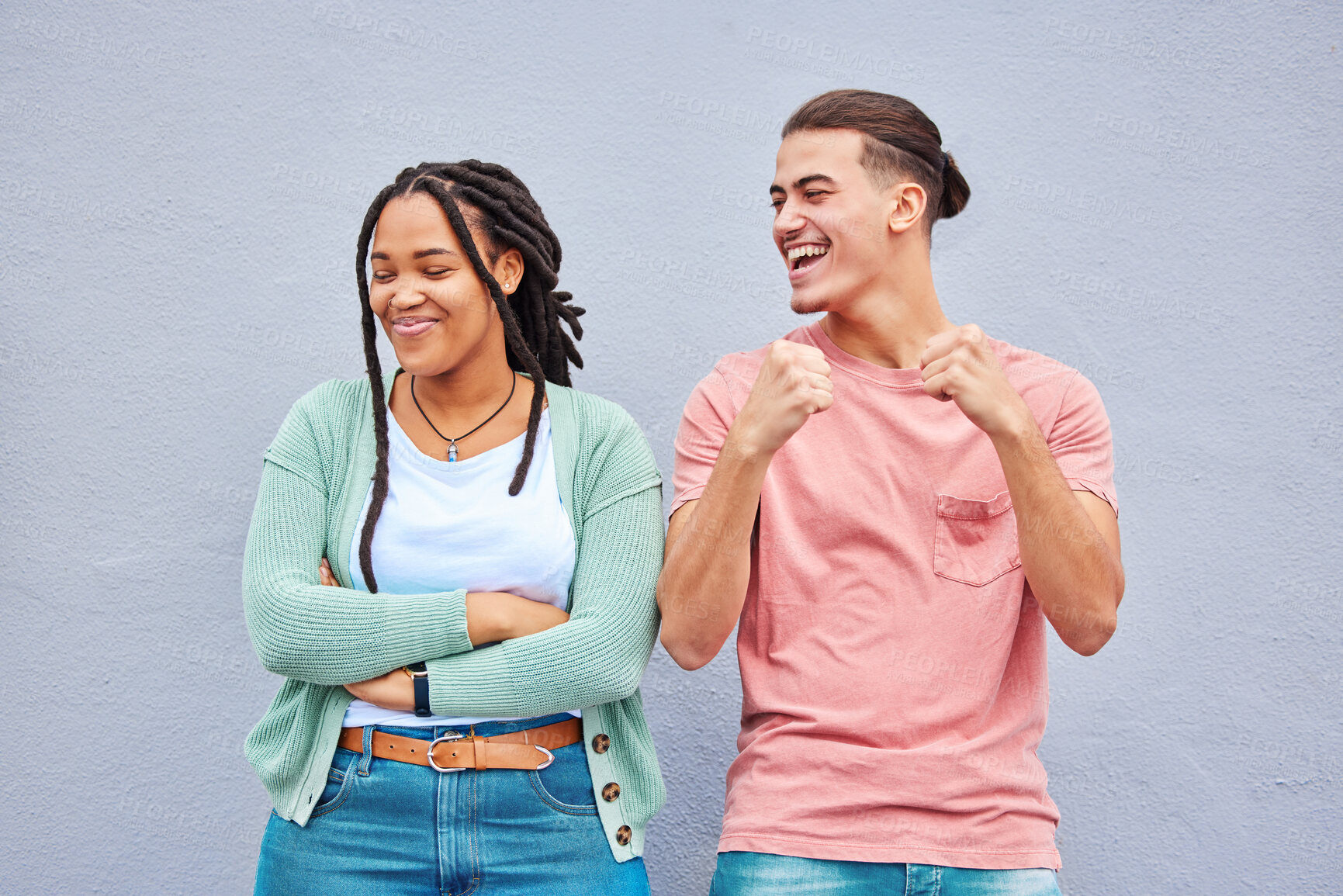 Buy stock photo Happy, laughing and interracial couple being funny together isolated on a background. Comic, smile and dancing man with a black woman with arms crossed and pride after a fight on a wall backdrop