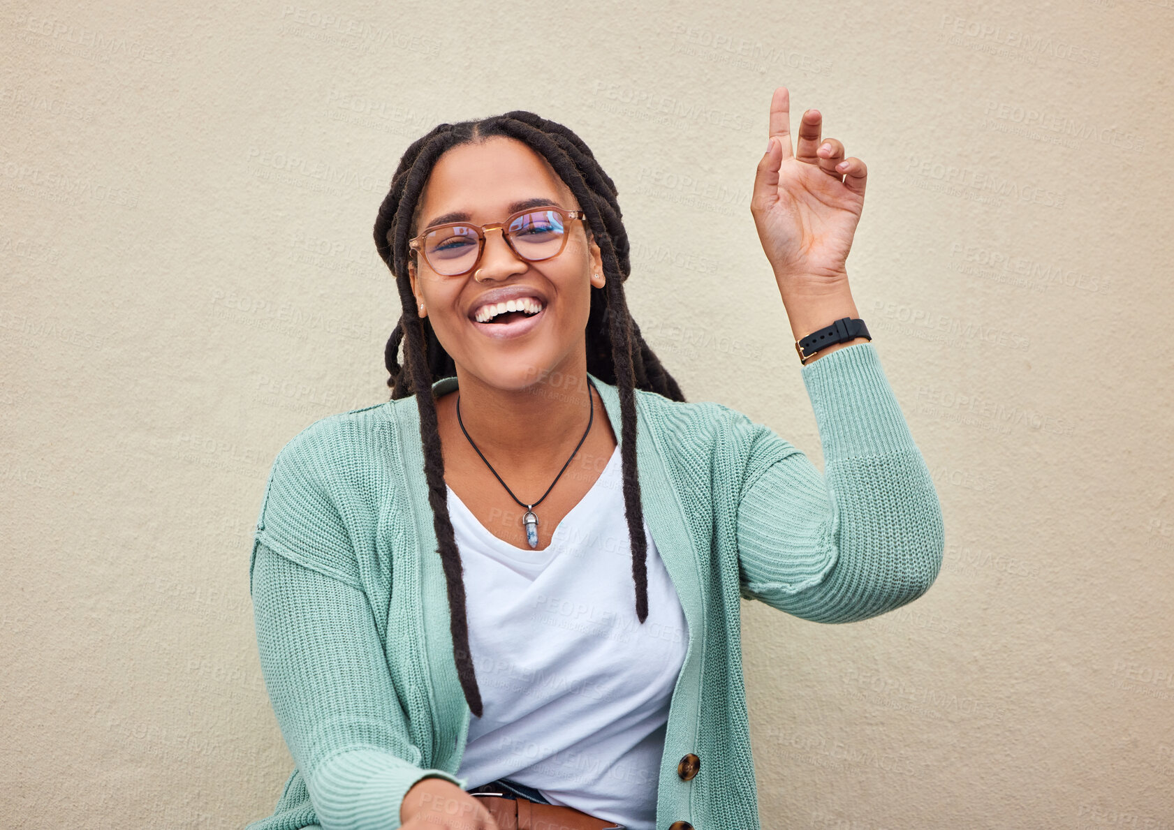 Buy stock photo Hand, sign and woman with mockup in studio for advertising, questions and space on wall background. Face, direction and hand gesture by happy, smile and cheerful girl showing product placement offer