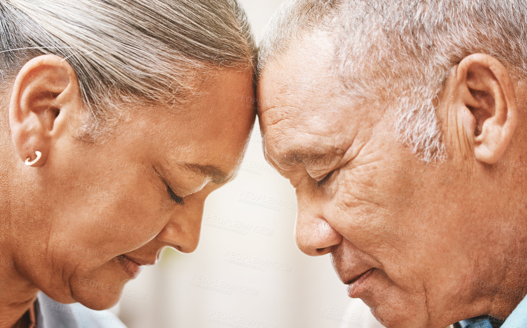 Buy stock photo Face, love and support with a senior couple in their home, touching heads in trust or solidarity together. Relax, peace or romance with a mature man and woman bonding in their house during retirement