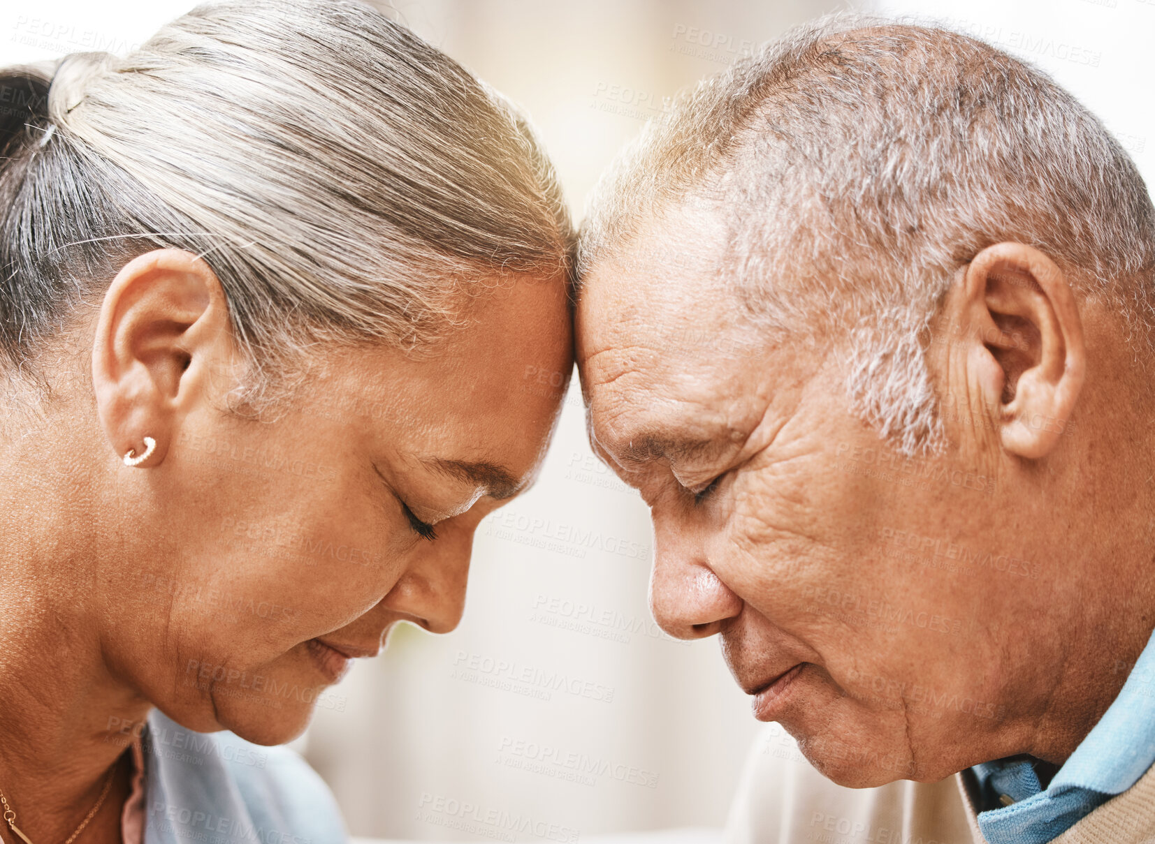 Buy stock photo Face, love and trust with a senior couple in their home, touching heads in support or solidarity together. Relax, peace or romance with a mature man and woman bonding in their house during retirement